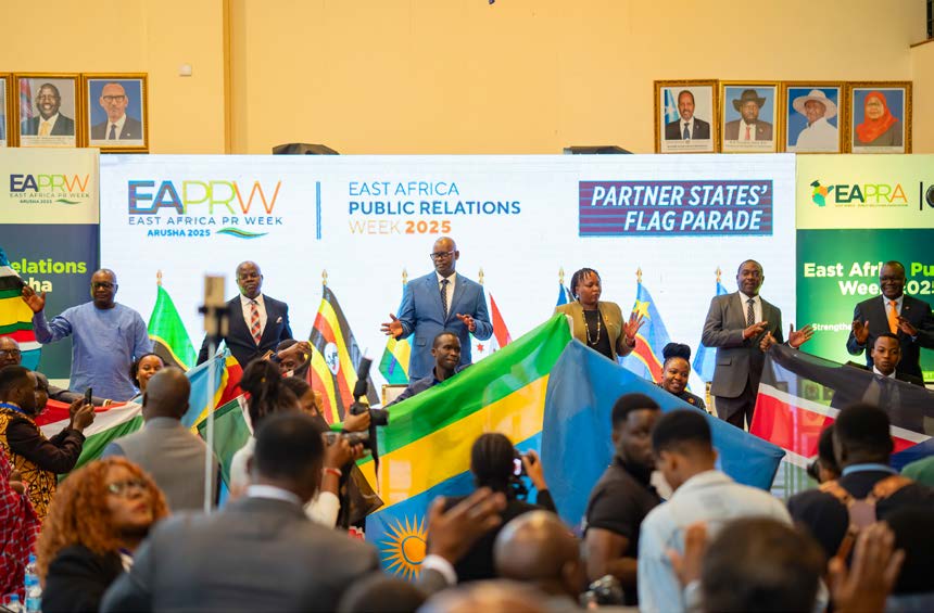 Delegates carrying the partner states' flags during the flag parade at East Africa PR Week 2025 in Arusha